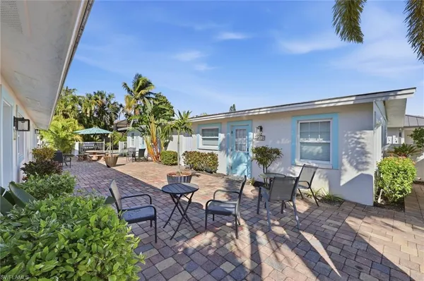 a view of a patio with table and chairs and potted plants