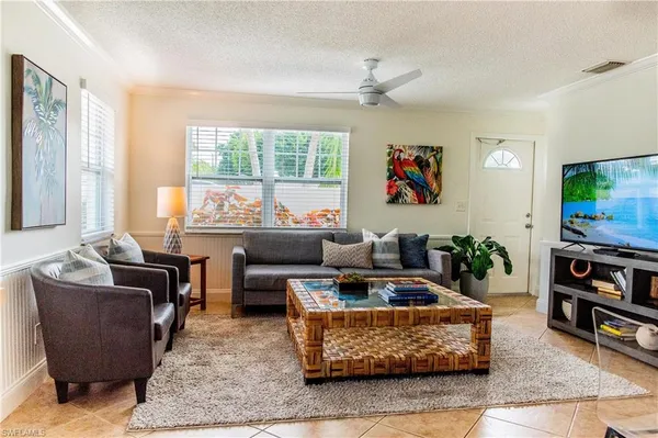 a living room with furniture and a flat screen tv