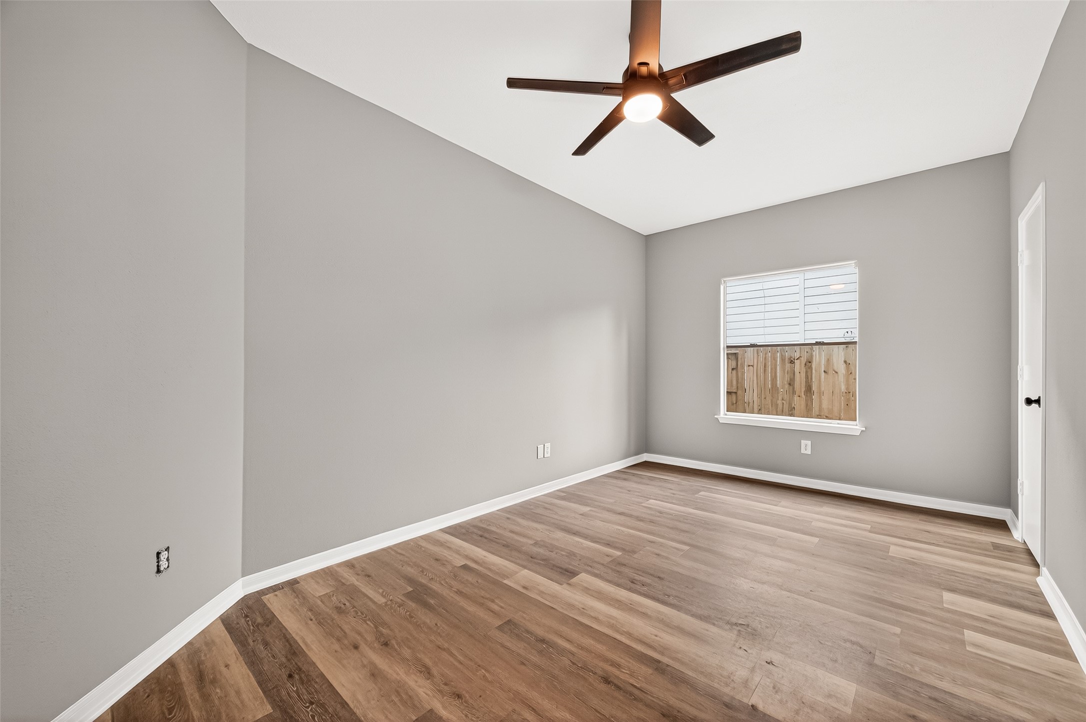 23810 Spring Way Drive Spring, TX 77373 - Photo 25 of 35 an empty room with wooden floor ceiling fan and windows