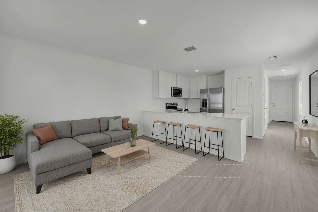 Open-concept living area with light wood-finish flooring