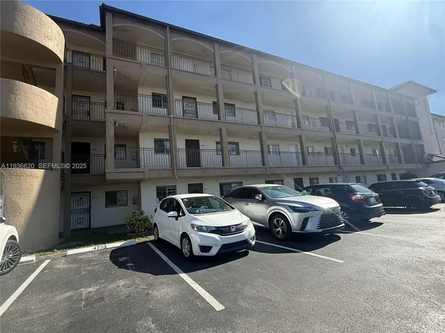 a front view of a building with parking space