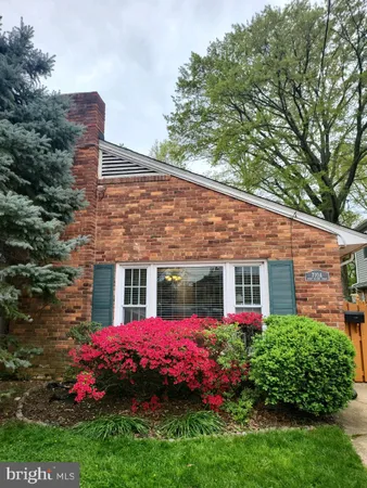 a view of a house with a big yard and potted plants