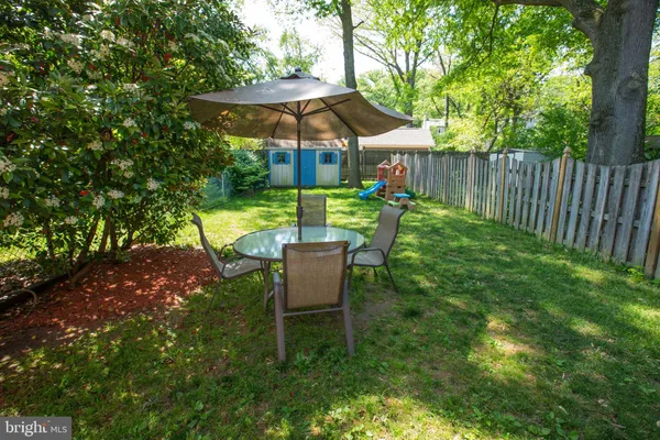 a view of a chair and table under an umbrella