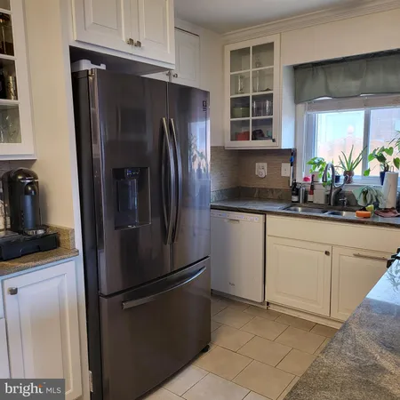 a kitchen with stainless steel appliances a refrigerator sink and cabinets