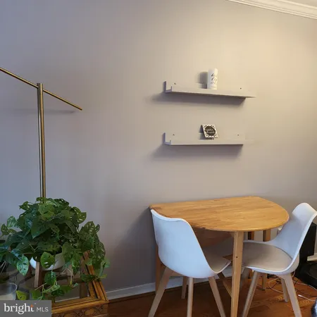 a view of a workspace with furniture and wooden floor