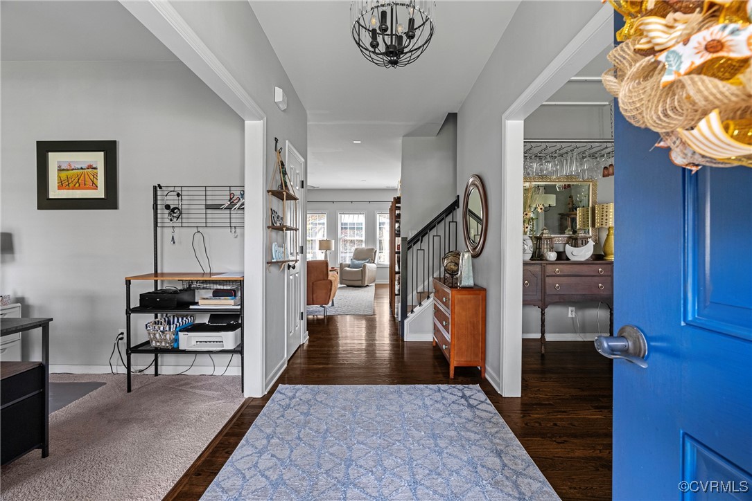 Foyer entrance with dark hardwood / wood-style flo