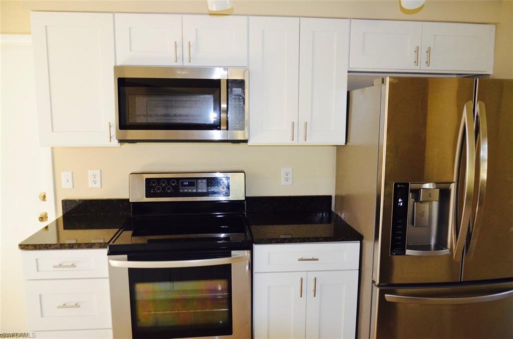 17981 North River Road Alva, FL 33920 - Photo 3 of 25 a kitchen with a stove and a refrigerator