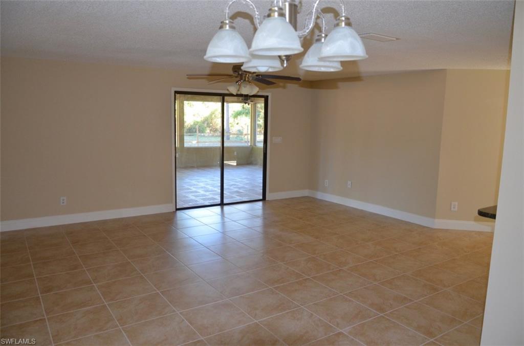 17981 North River Road Alva, FL 33920 - Photo 7 of 25 an empty room with wooden floor and chandelier