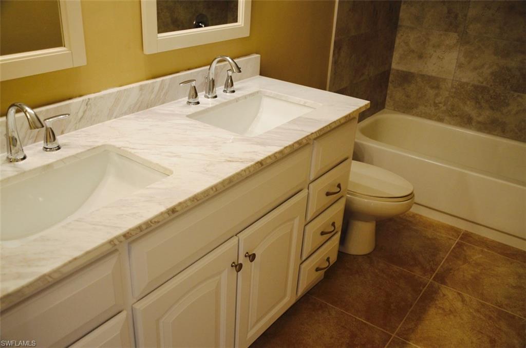 17981 North River Road Alva, FL 33920 - Photo 8 of 25 a bathroom with a granite countertop sink a toilet and bathtub