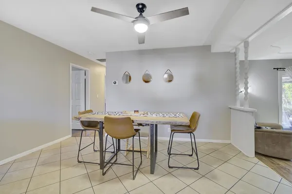 a view of a kitchen with furniture and a refrigerator