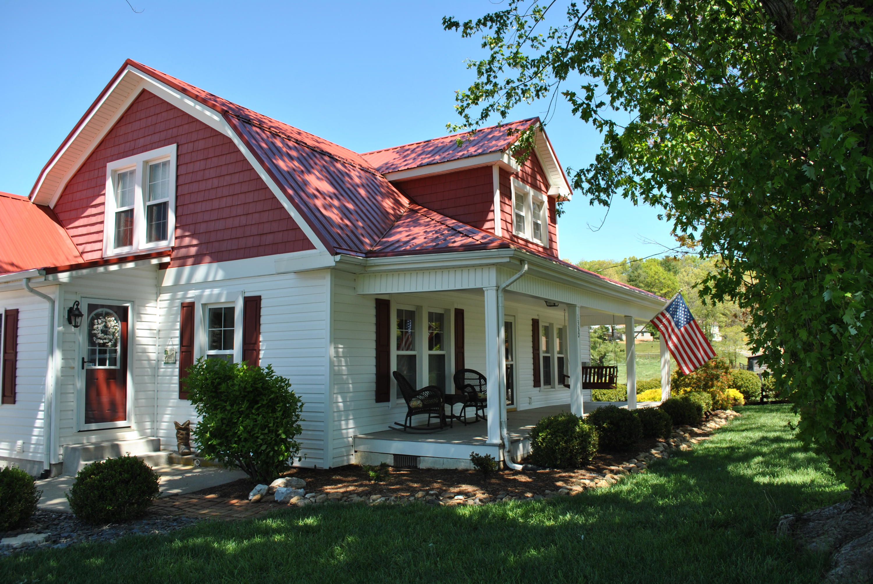 a view of a house with brick walls and a yard with plants