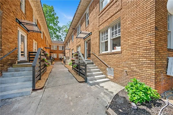 a view of a brick building next to a yard