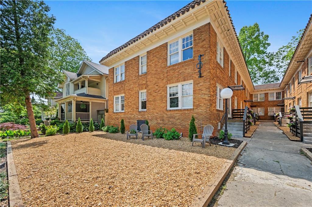 405 4th Street Northeast, Unit 8 Atlanta, GA 30308 - Photo 12 of 12 a view of a brick building next to a yard