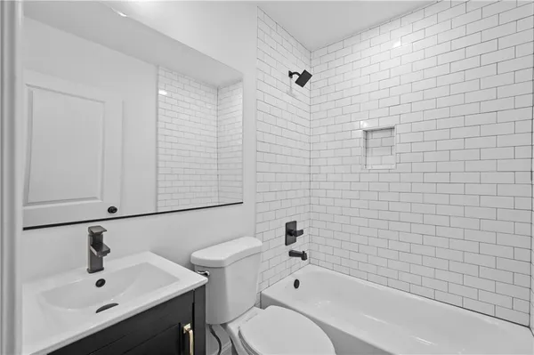 a bathroom with a sink a toilet and bathtub