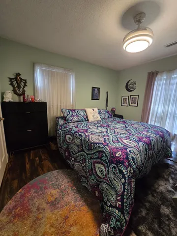 a bedroom with a bed and a chandelier