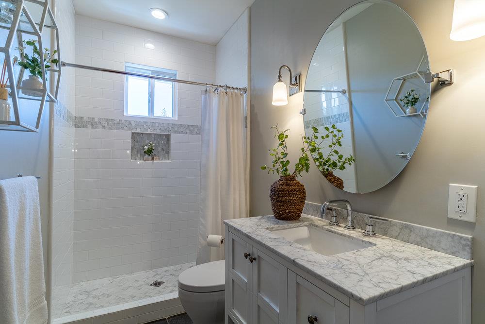 14832 Acton Drive San Jose, CA 95124 - Photo 27 of 47 a bathroom with a granite countertop sink and a mirror