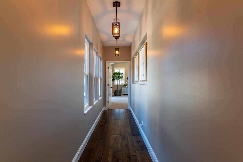 14832 Acton Drive San Jose, CA 95124 - Photo 28 of 47 a view of a hallway with wooden floor and chandelier