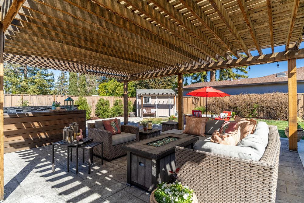 14832 Acton Drive San Jose, CA 95124 - Photo 41 of 47 an outdoor sitting area with furniture and umbrella