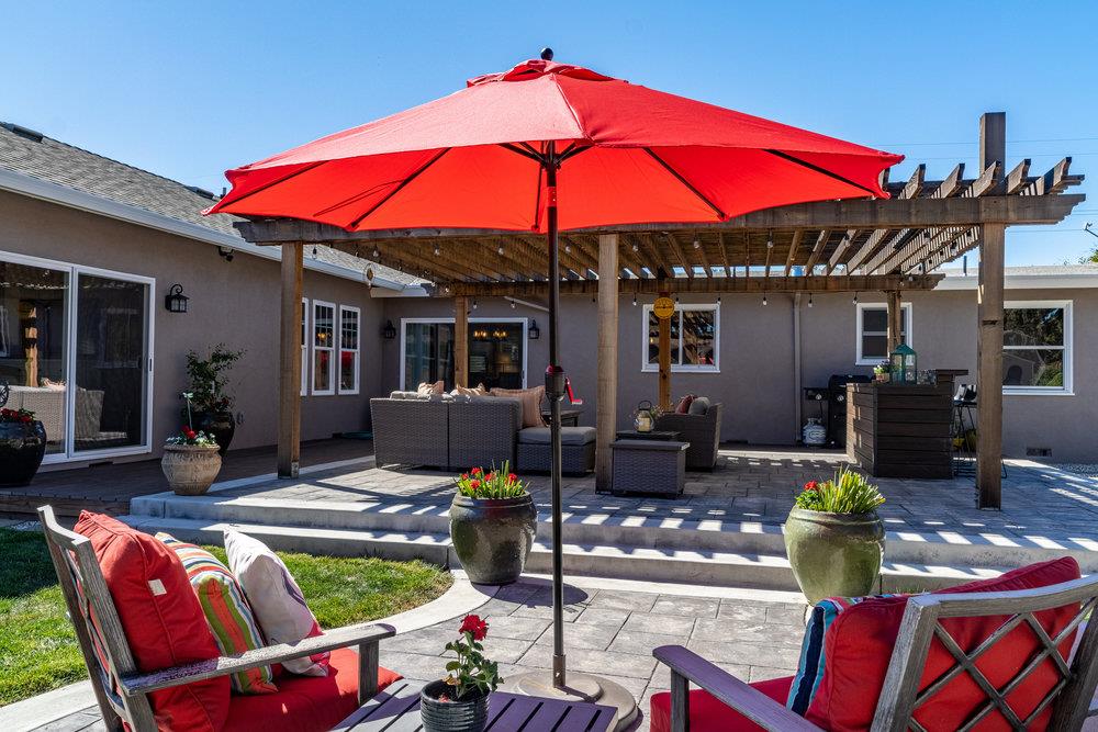 14832 Acton Drive San Jose, CA 95124 - Photo 46 of 47 a patio with tables and chairs a fire pit and two lawn chairs
