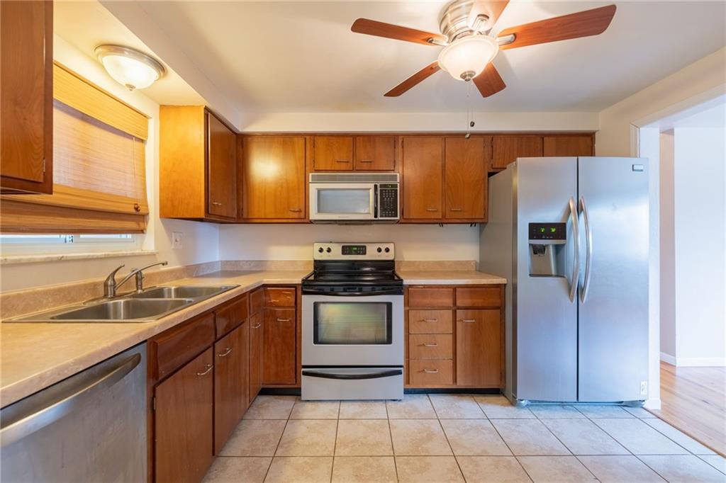 200 Foxcroft Road Pittsburgh, PA 15220 - Photo 7 of 43 a kitchen with a sink cabinets and stainless steel appliances