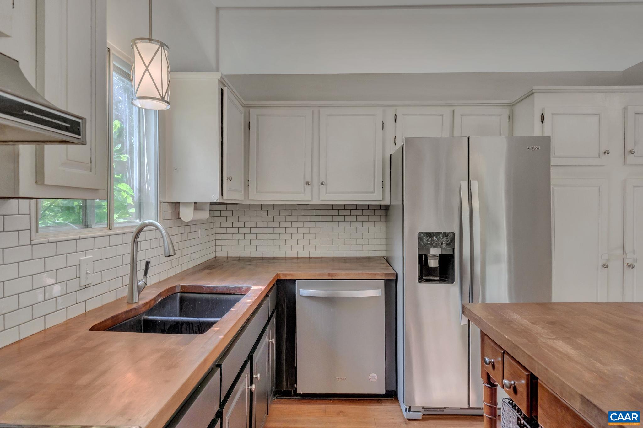707 Village Road Charlottesville, VA 22903 - Photo 18 of 46 a kitchen that has a sink a stove and a refrigerator