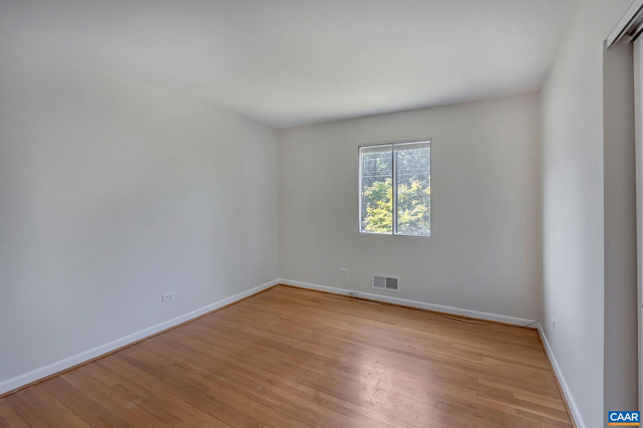 707 Village Road Charlottesville, VA 22903 - Photo 25 of 46 wooden floor in an empty room with a window