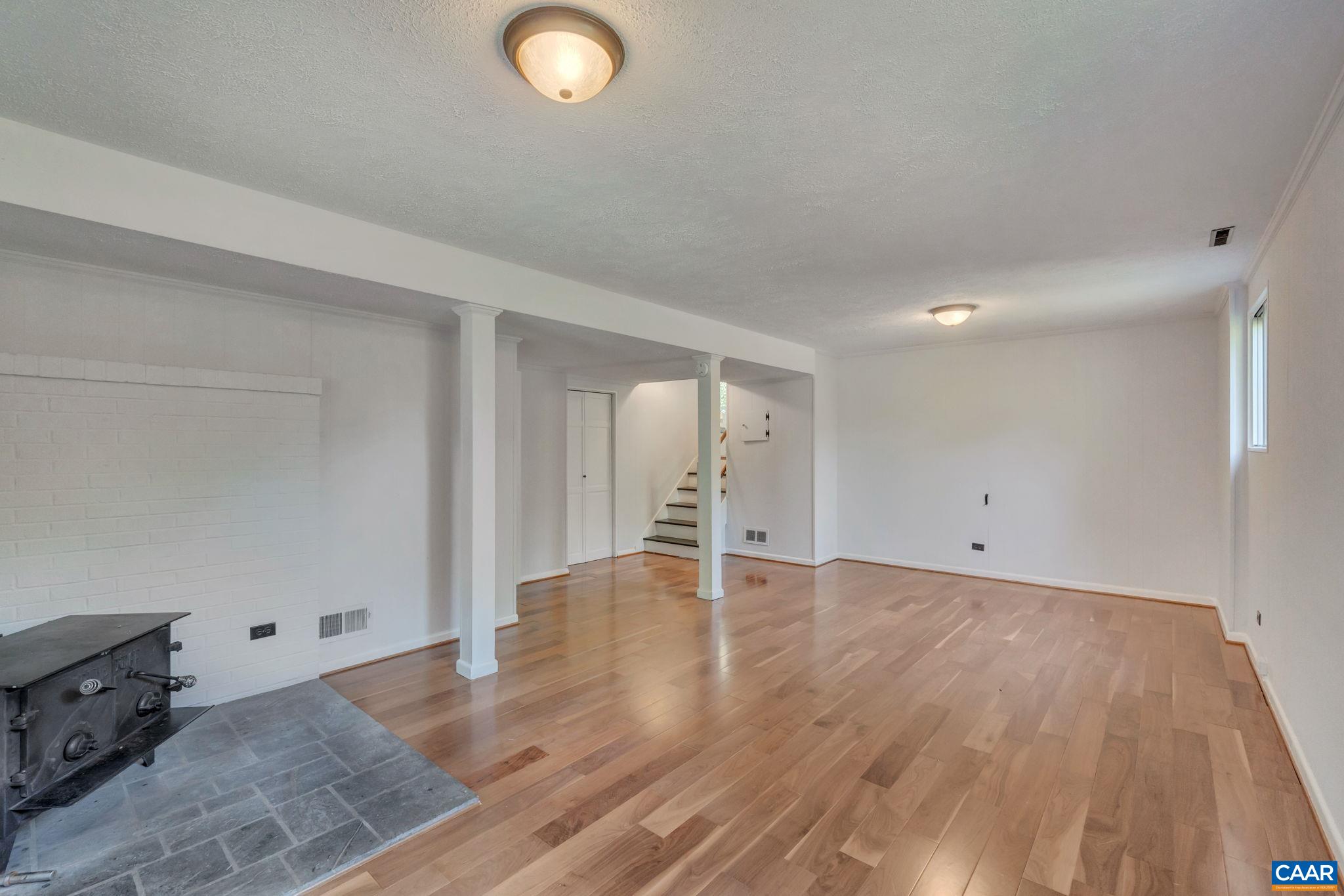 707 Village Road Charlottesville, VA 22903 - Photo 30 of 46 an empty room with wooden floor and windows