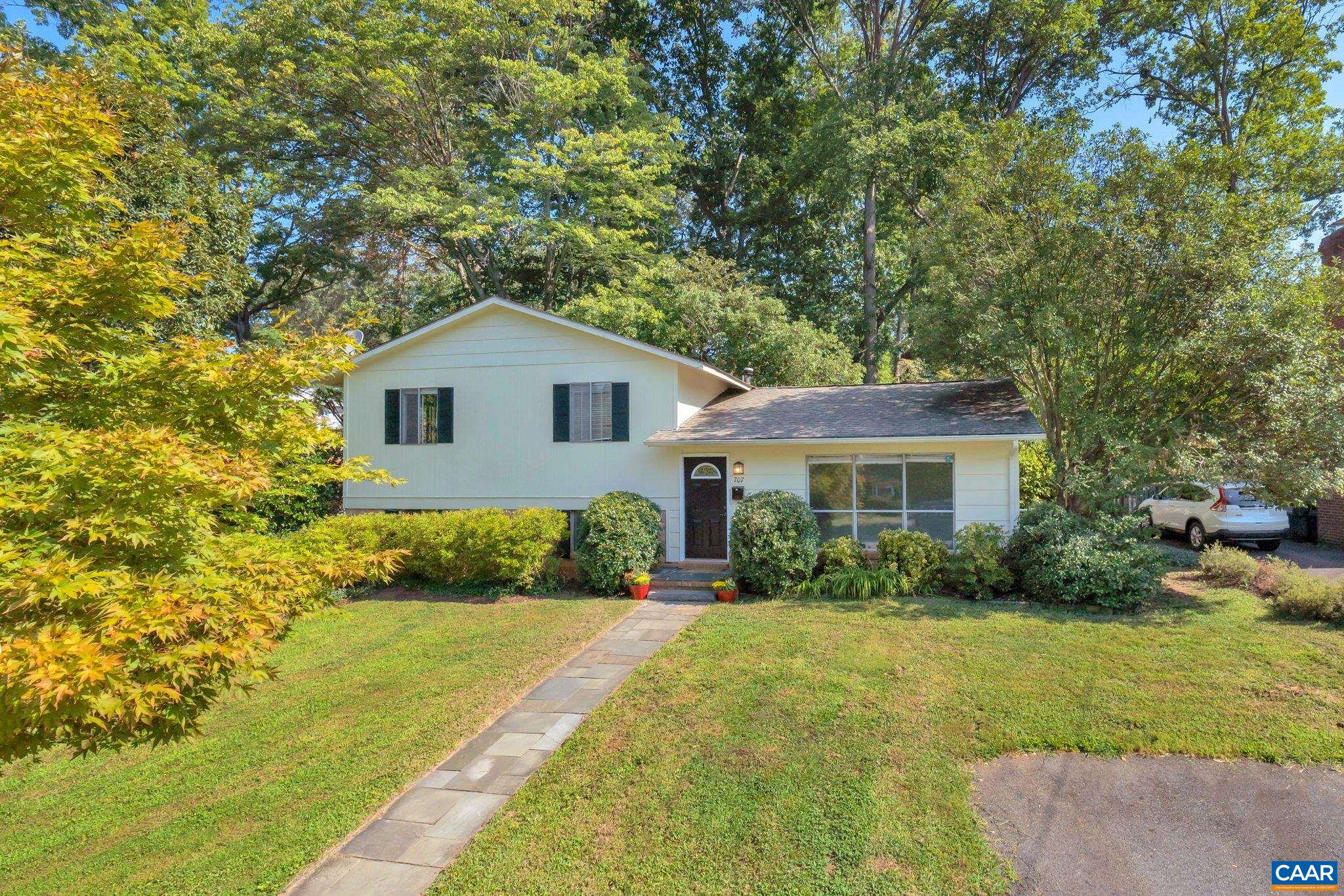 707 Village Road Charlottesville, VA 22903 - Photo 4 of 46 a front view of a house with a yard