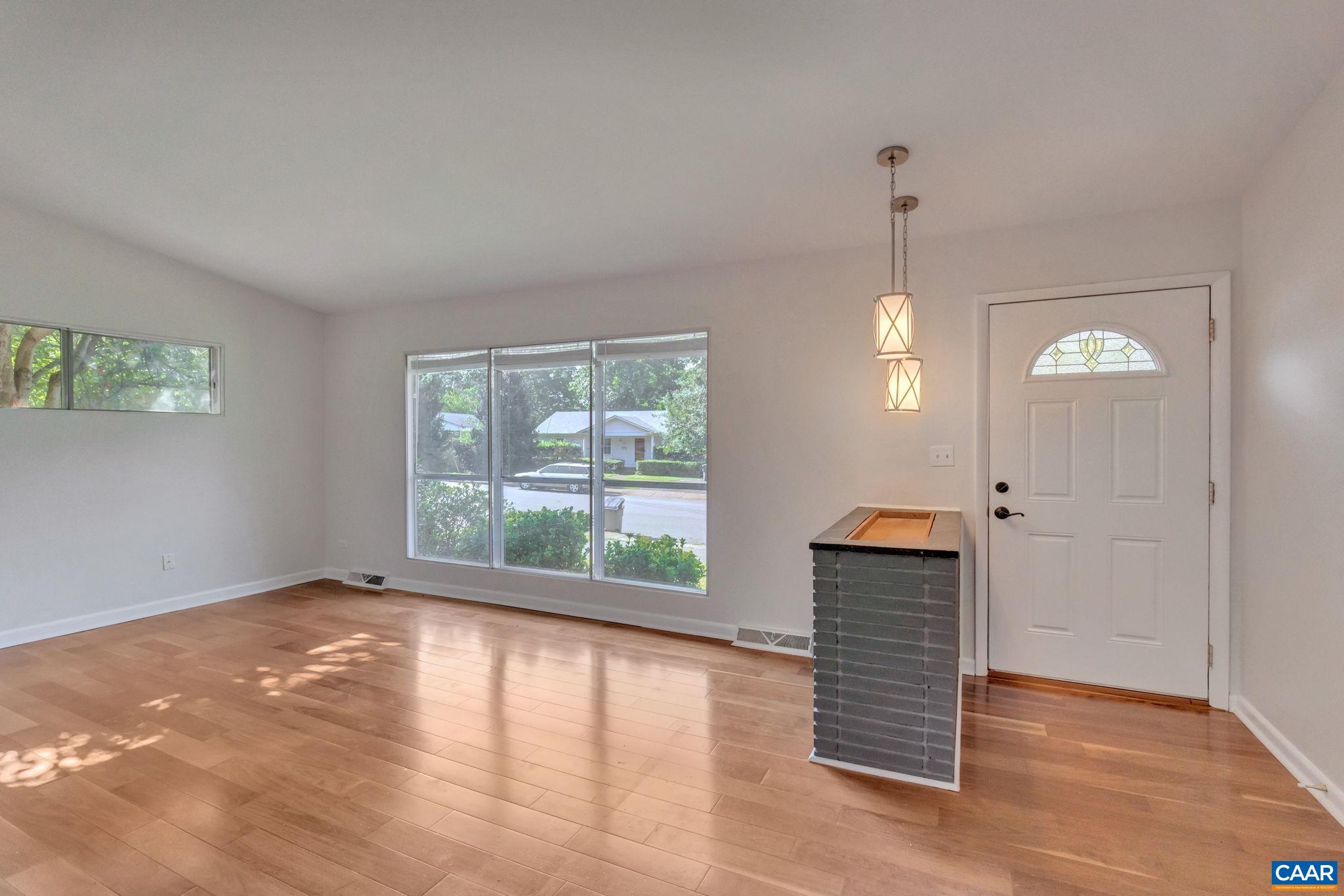707 Village Road Charlottesville, VA 22903 - Photo 7 of 46 a view of empty room with wooden floor and fan