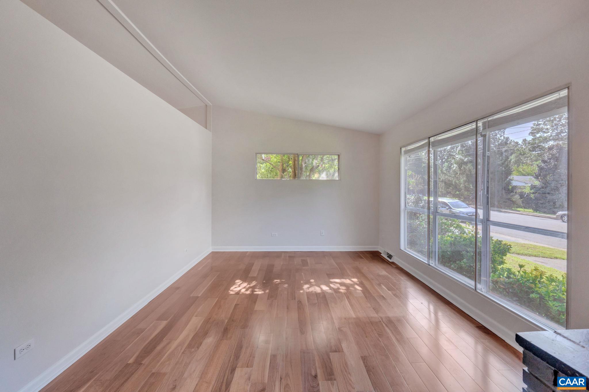 707 Village Road Charlottesville, VA 22903 - Photo 8 of 46 an empty room with wooden floor and windows