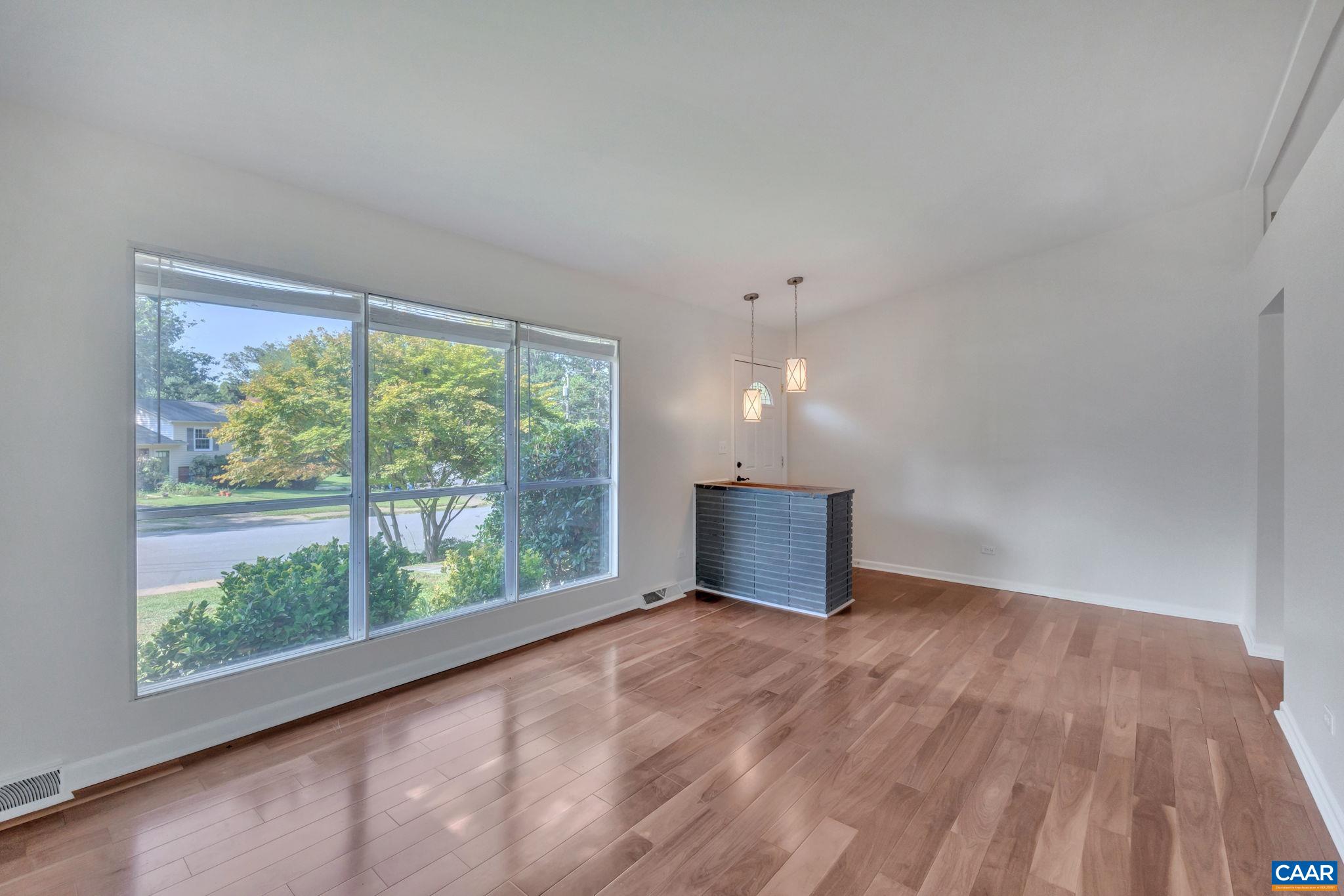 707 Village Road Charlottesville, VA 22903 - Photo 9 of 46 a view of an empty room with wooden floor and a window