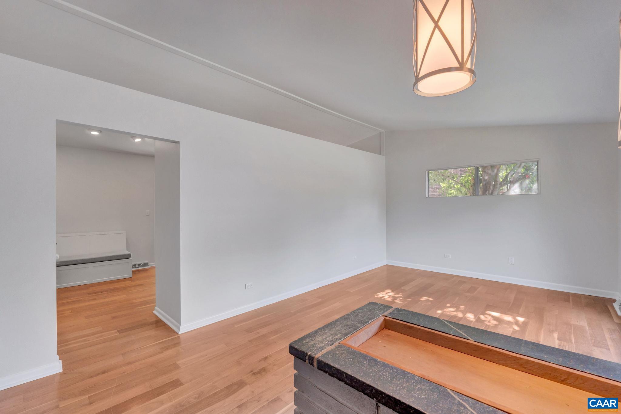707 Village Road Charlottesville, VA 22903 - Photo 10 of 46 an empty room with wooden floor and windows