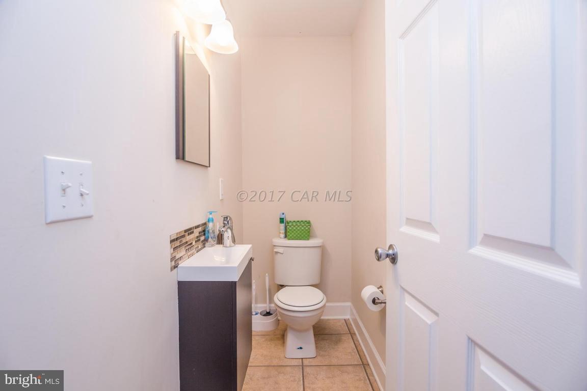 29632 Deal Island Road Princess Anne, MD 21853 - Photo 28 of 33 a white toilet sitting next to a bathroom sink