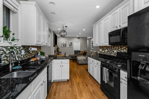 a kitchen with stainless steel appliances a stove sink microwave and cabinets