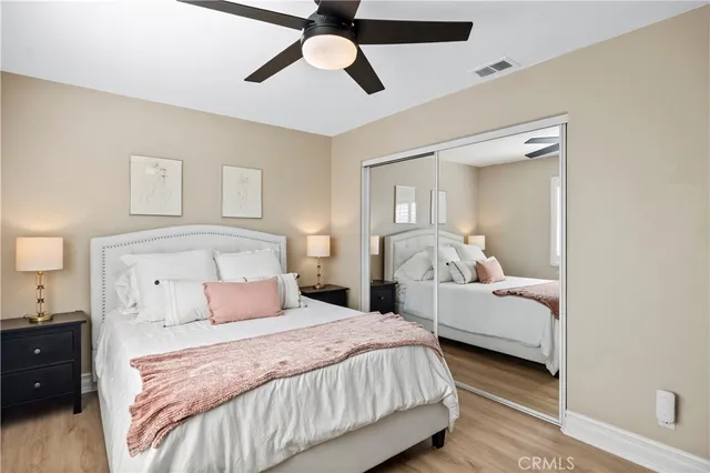 a bedroom with a bed and wooden floor