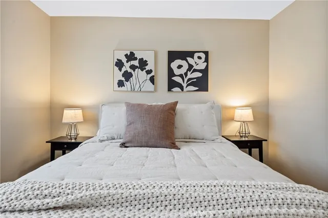 a bathroom with a granite countertop sink a large mirror and a shower