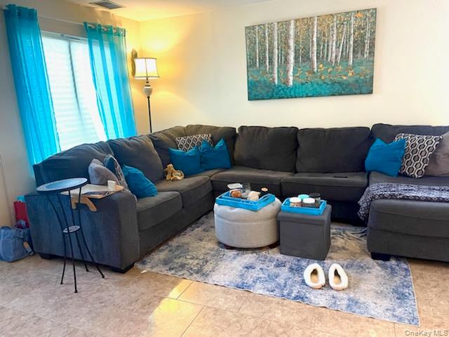 112 Birchwood Road Coram, NY 11727 - Photo 2 of 6 a living room with furniture and a window