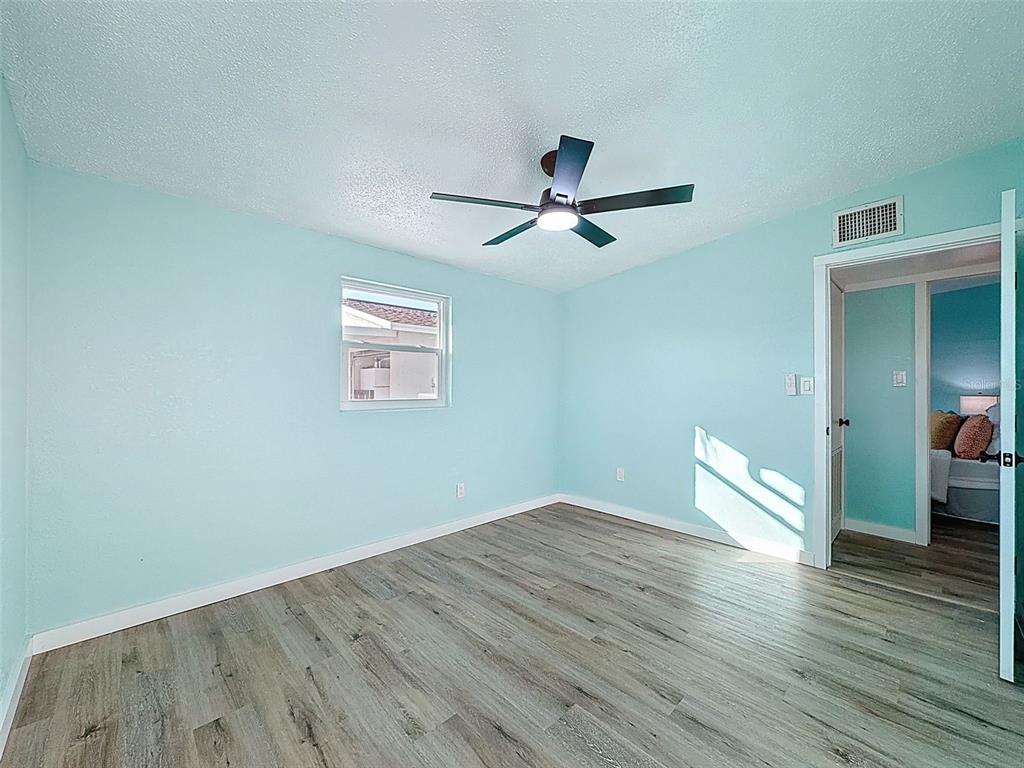 6827 Sanderling Lane Hudson, FL 34667 - Photo 23 of 68 a view of empty room with wooden floor