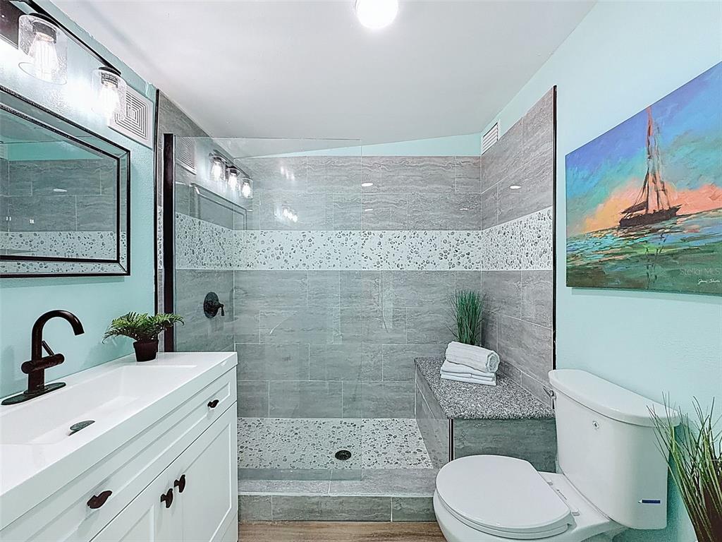 6827 Sanderling Lane Hudson, FL 34667 - Photo 29 of 68 a bathroom with a sink a toilet and shower