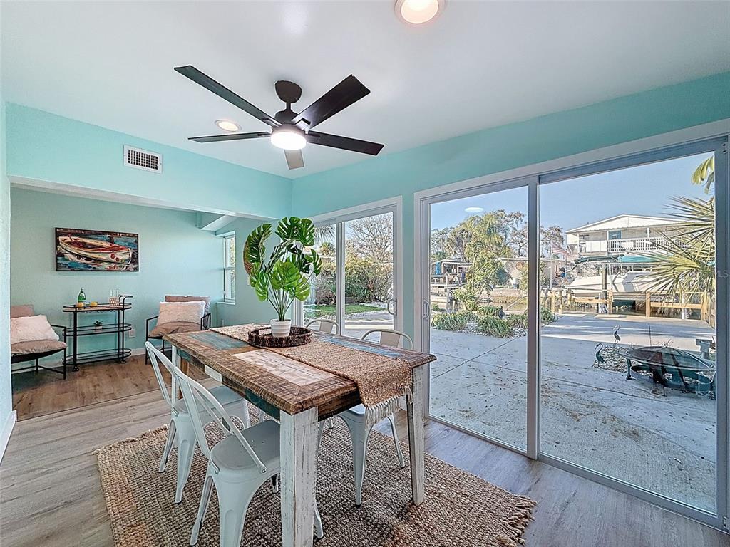 6827 Sanderling Lane Hudson, FL 34667 - Photo 35 of 68 a dining room with furniture a rug and a large window