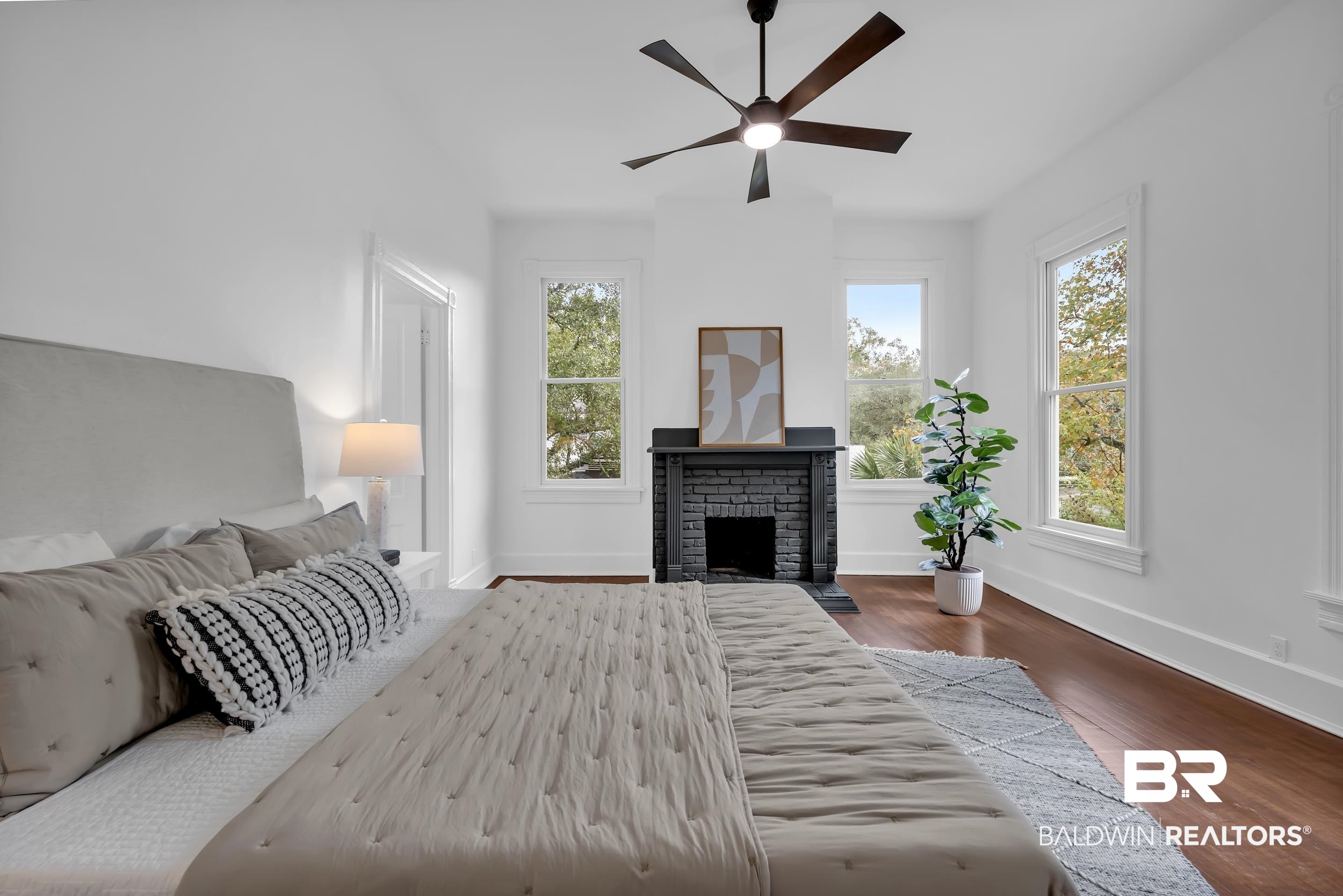 1662 Government Street Mobile, AL 36604 - Photo 24 of 33 Bedroom with dark wood-style floors, a brick fireplace, and a ceiling fan