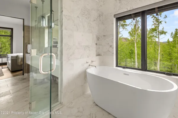 a bathroom with a bathtub and a shower