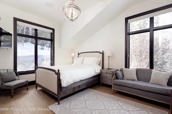 a bedroom with a bed couch and window