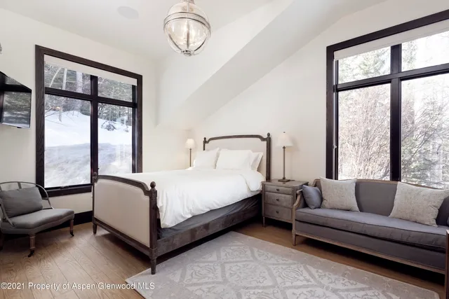 a bedroom with a bed couch and window