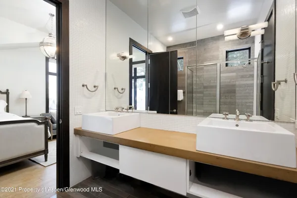 a bathroom with a sink double vanity and a shower