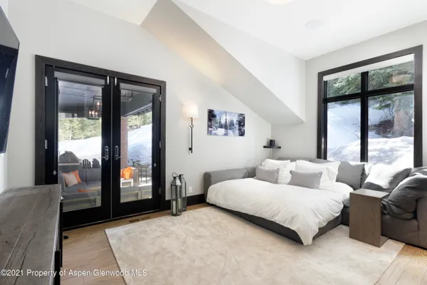 a bedroom with a large bed and a large window