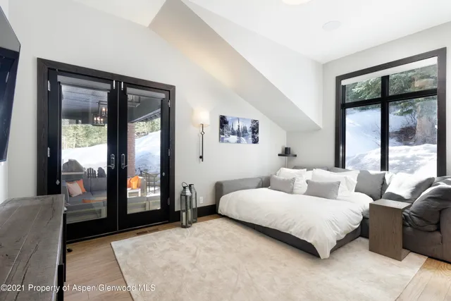 a bedroom with a large bed and a large window