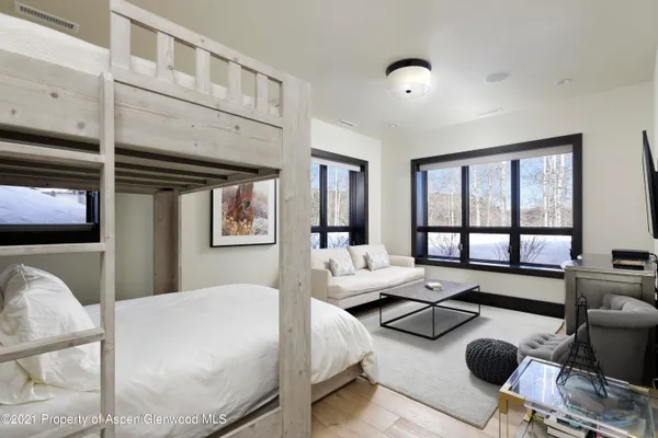 a bedroom with furniture and a large window