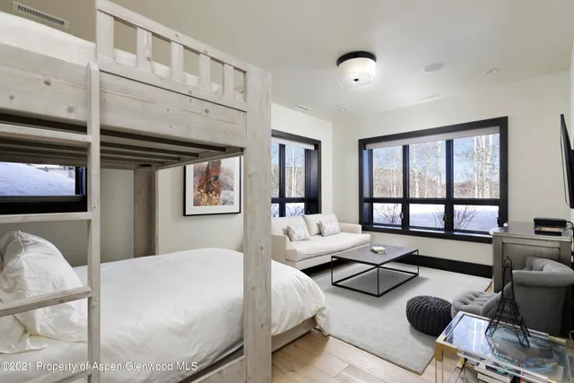 a bedroom with furniture and a large window