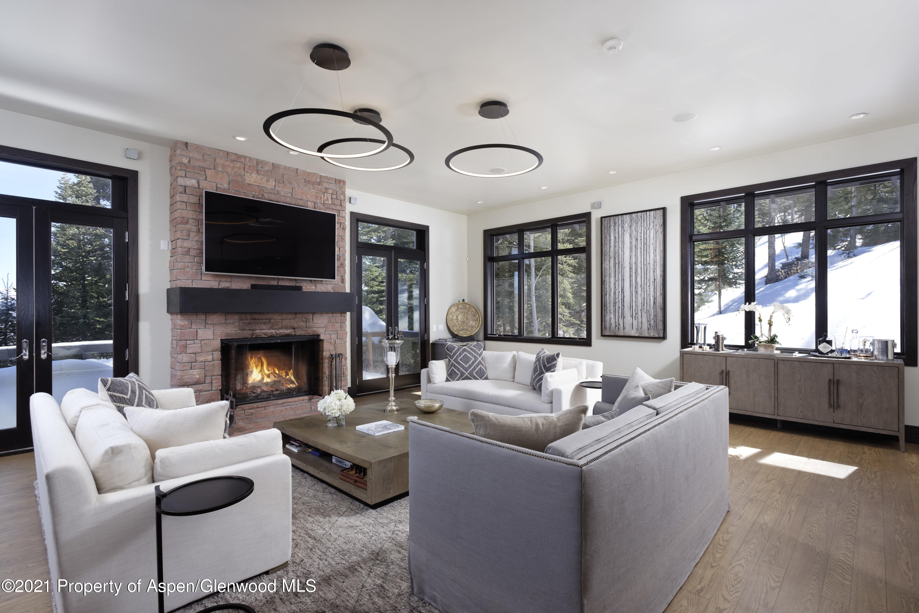 32 Elk Ridge Lane Snowmass Village, CO 81615 - Photo 2 of 34 a living room with furniture a fireplace and a flat screen tv